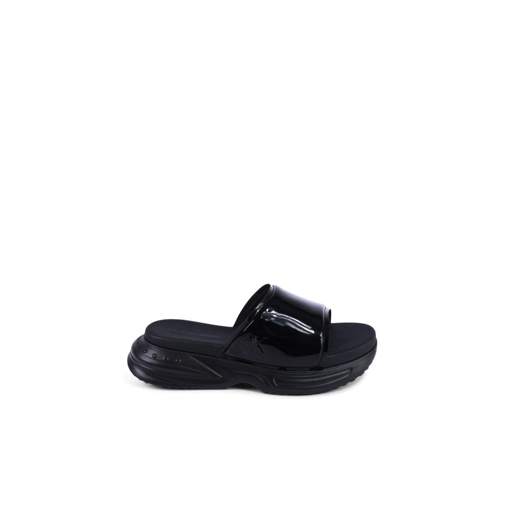 Calvin Klein Black Polyurethane Slides for women, model YW0YW014040GT, made of 100% thermoplastic polyurethane, side view.