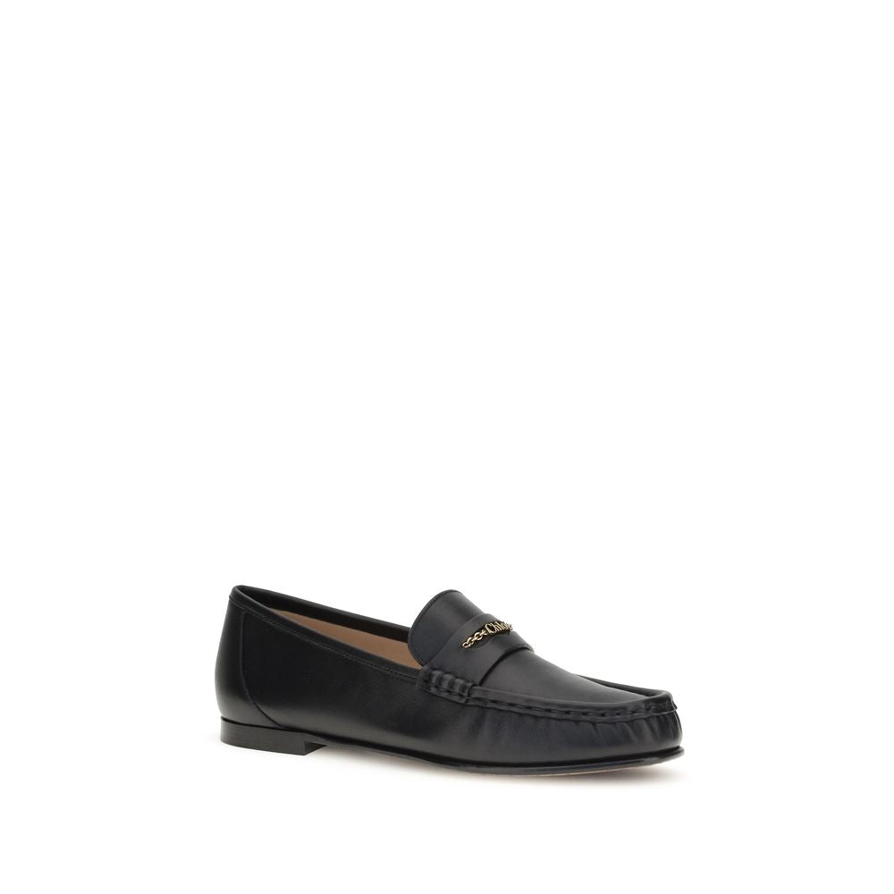 Chloé Black Calf Leather Bos Taurus Slip-On Loafers with gold chain detail and elegant silhouette.