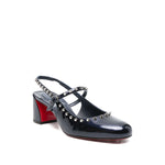 Christian Louboutin Janispikes pumps in dark blue patent leather with studded embellishments, slingback strap, and block heel.