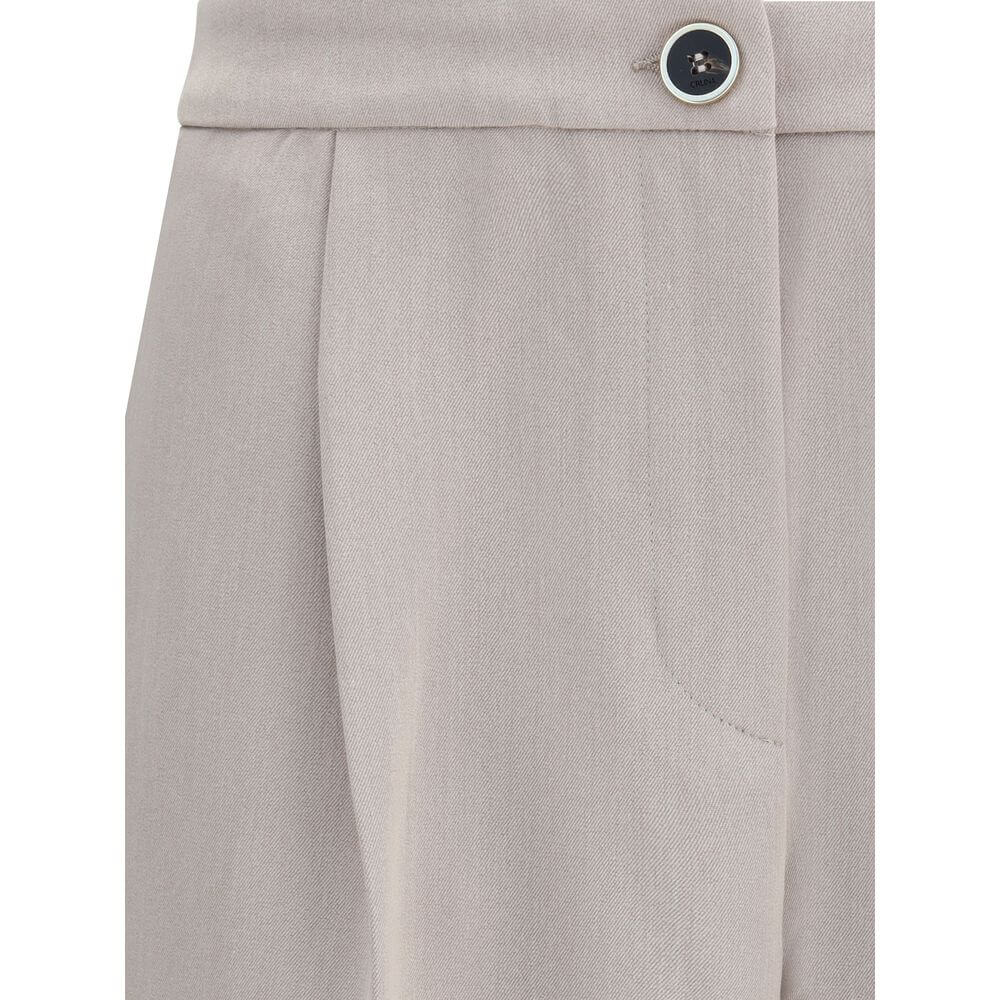 Close-up of Cruna Beige Polyester Casual Pants showing front button detail and side pocket.