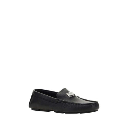 Dolce & Gabbana Black Rubber Slip-On Loafers with calf leather upper and metal monogram plaque, perfect for AW25 season.