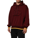 Dolce & Gabbana Maroon Embossed Logo Hooded Sweatshirt Sweater on model, featuring luxurious cotton blend, ideal for casual or luxury wear.