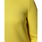 Close-up of Dolce & Gabbana Yellow Viscose Acetate Mini Long Sleeve Dress fabric and shoulder detail.