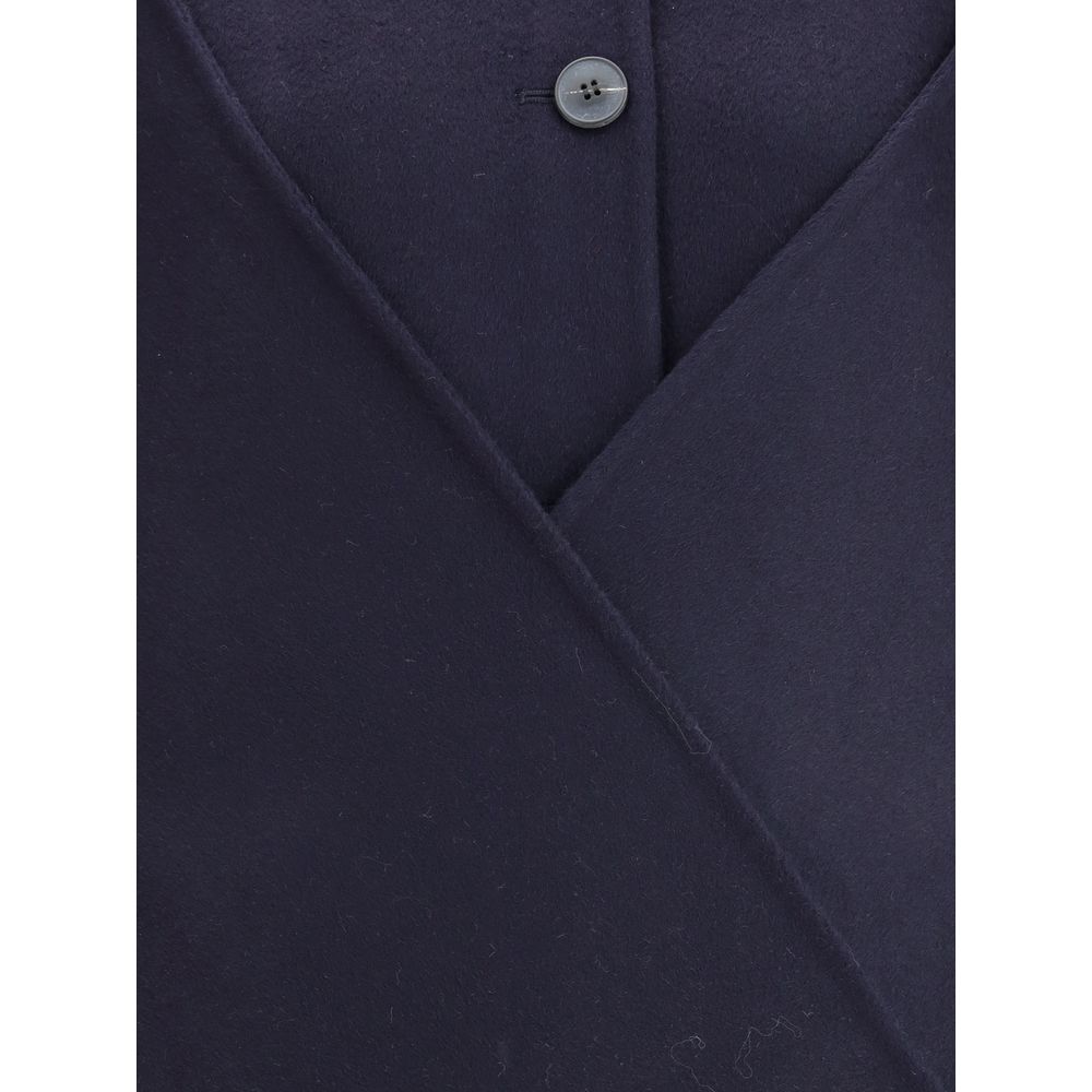 Close-up of Dynamis Studio Blue Wool Coat with button closure and visible wool texture.