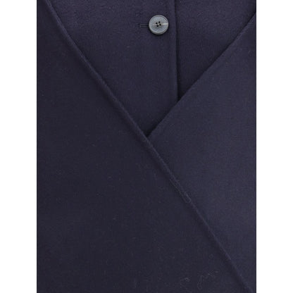 Close-up of Dynamis Studio Blue Wool Coat with button closure and visible wool texture.