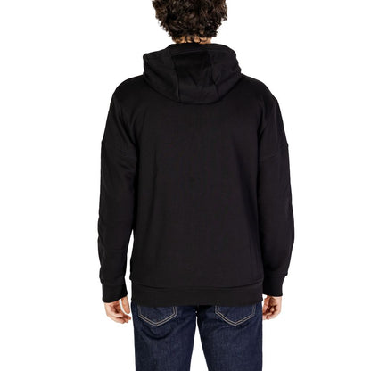 Back view of EA7 Emporio Armani Black Cotton Hoodie worn by model, featuring adjustable hood and modern design, ideal for casual wear.
