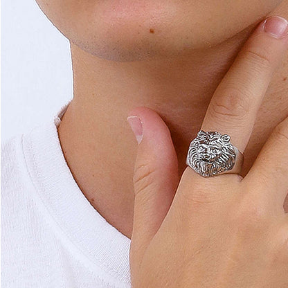 Person wearing lion face ring on finger, close-up view