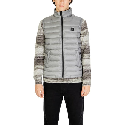 Gianni Lupo Gray Polyamide Sleveless Jacket with quilted design and front zip, worn by model for stylish winter look.