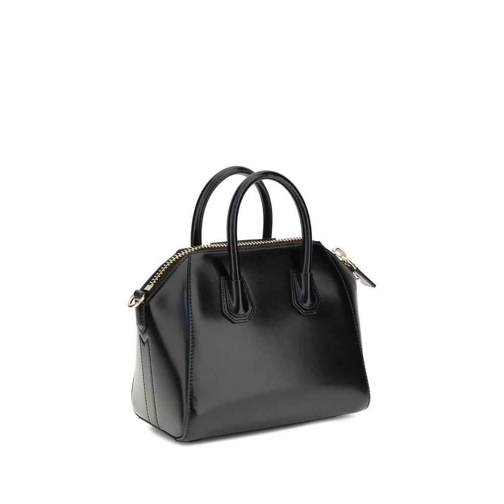 Givenchy Black Calf Leather Bos Taurus Handbag with geometric pattern, dual handles, and detachable strap; iconic monogram on front.