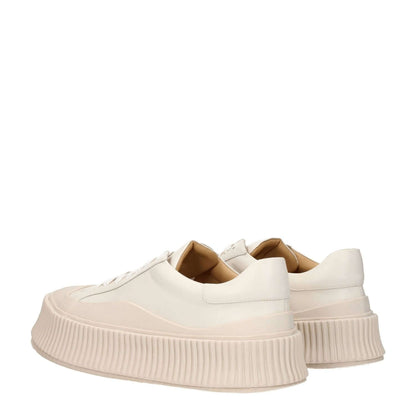 Jil Sander Beige Leather Platform Sneakers with a round toe and wedge heel, featuring an aged effect and lace-up closure.