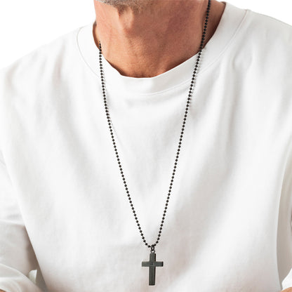 Man wearing cross necklace on white shirt