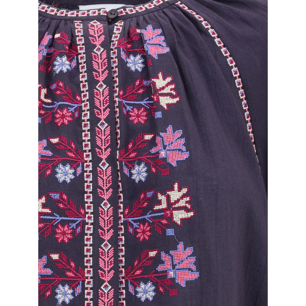 Detailed embroidery on Marant Etoile Blue Cotton Blouse showcasing intricate cross-stitch patterns and buttons.