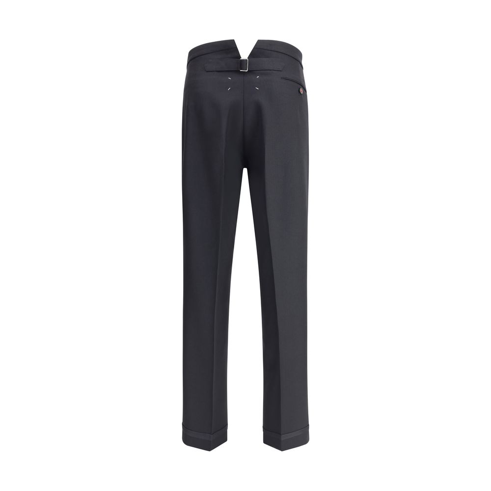 Margiela Black Wool Dress Pants with pleated design and logo closure, featuring turn-ups and iconic white stitching detail.