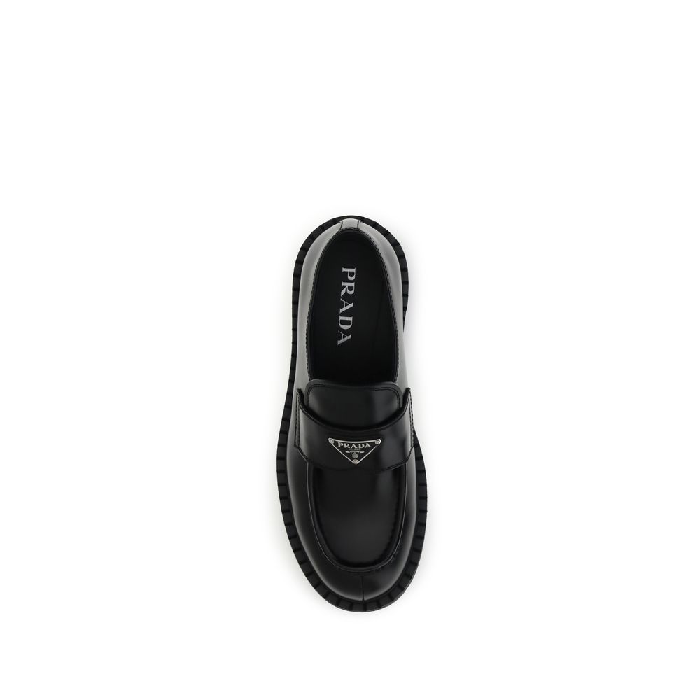 Prada Black Calf Leather Bos Taurus Slip-On Loafers top view with enameled triangle symbol and rubber sole.