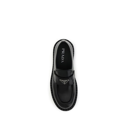 Prada Black Calf Leather Bos Taurus Slip-On Loafers top view with enameled triangle symbol and rubber sole.