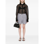 Woman wearing SportMax black striped shorts with elastic waistband, front button, and zip fastening, paired with a sheer black shirt.