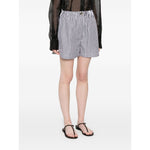 Model wearing SportMax black striped cotton shorts with elastic waistband, front button, zip fastening, and four pockets.