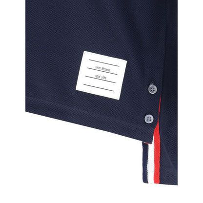 Close-up of Thom Browne Blue Cotton T-Shirt with logo patch, buttons, and iconic colored bands.