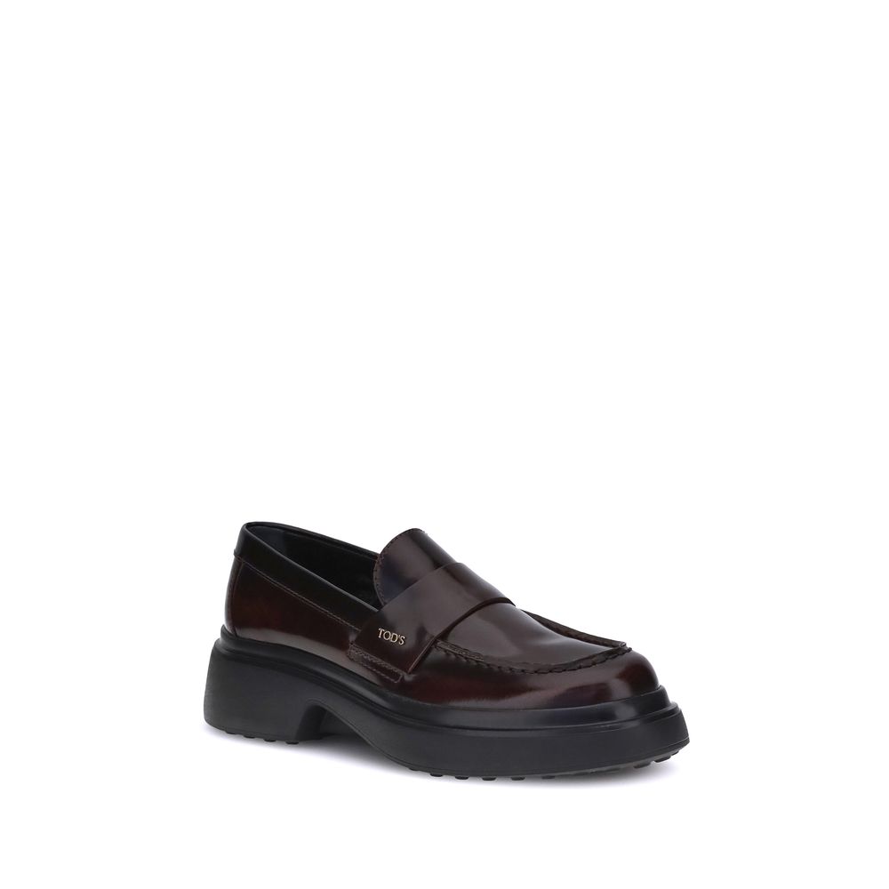 Tod's Brown Rubber Platform Loafers with calf leather upper and rounded toe, featuring a side logo plaque for a modern, elegant design.