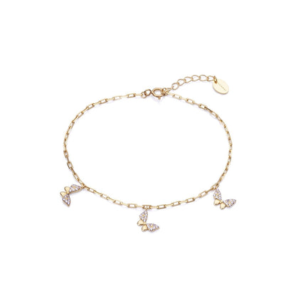 Delicate gold butterfly charm bracelet on a white background.