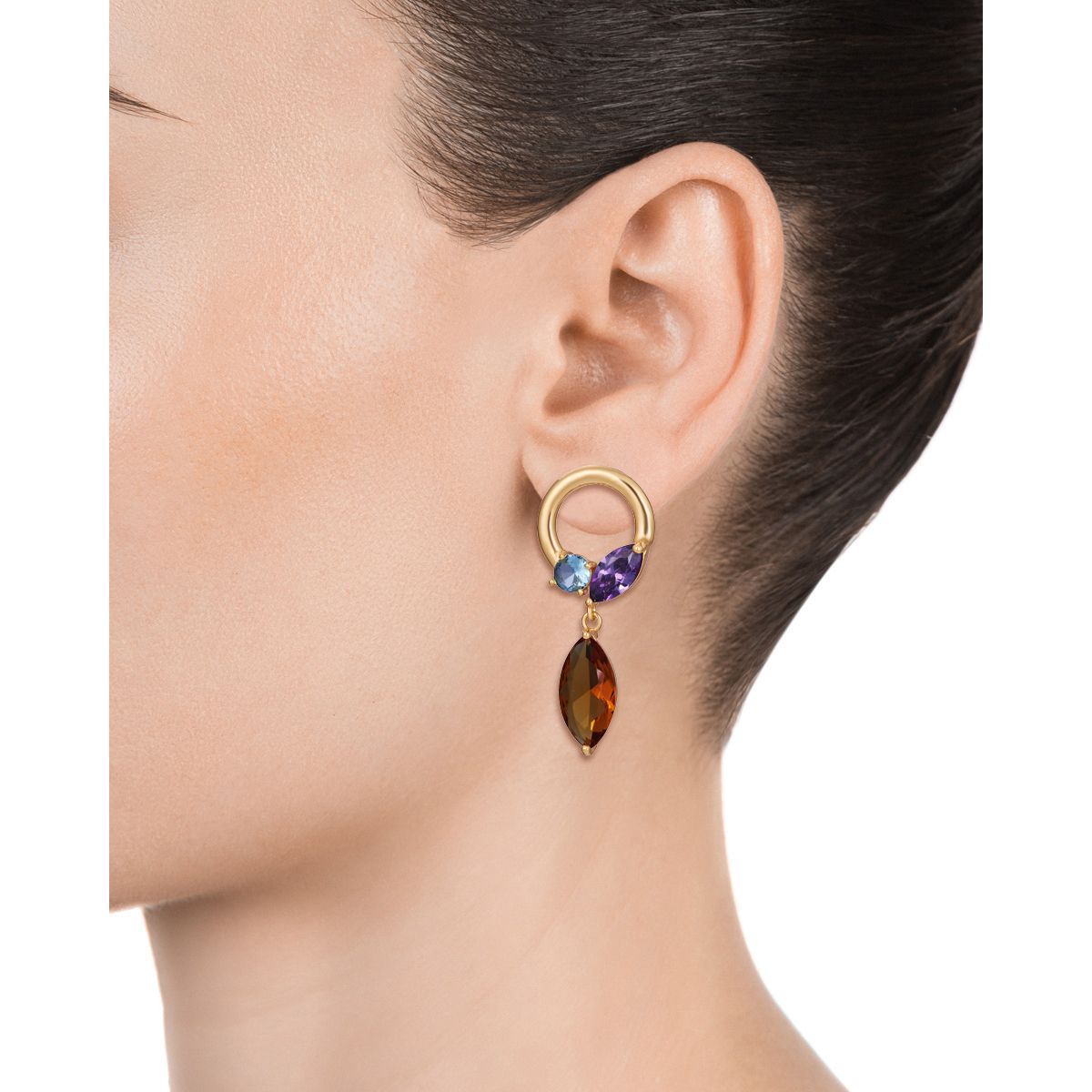 Model wearing colorful gemstone earrings with a gold loop design, showcasing unique styling in fashion accessories.
