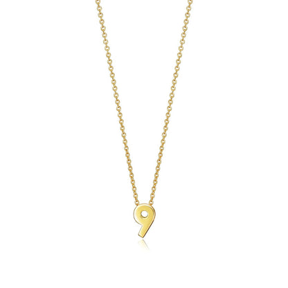 Gold necklace with a pendant in the shape of the number 9, displayed on a white background, showcasing elegant jewelry design.