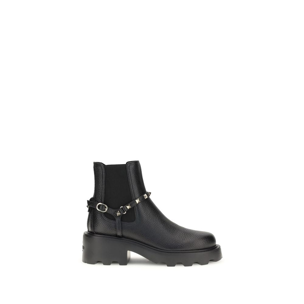 Valentino Garavani Black Calf Leather Bos Taurus Ankle Boots with metal studs and elastic inserts, AW25 collection, side view.