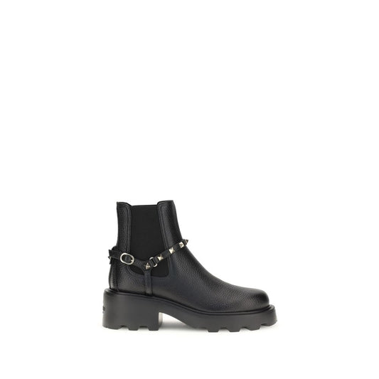 Valentino Garavani Black Calf Leather Bos Taurus Ankle Boots with studded strap and round toe, showcasing luxury and modern elegance.