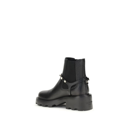 Valentino Garavani Black Calf Leather Bos Taurus Ankle Boots with metal studded strap and elastic insert for easy wear, side view