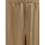 Valentino Monochrome Pants with elasticized waistband and drawstring, featuring front zipper, button closure, and side slash pockets.