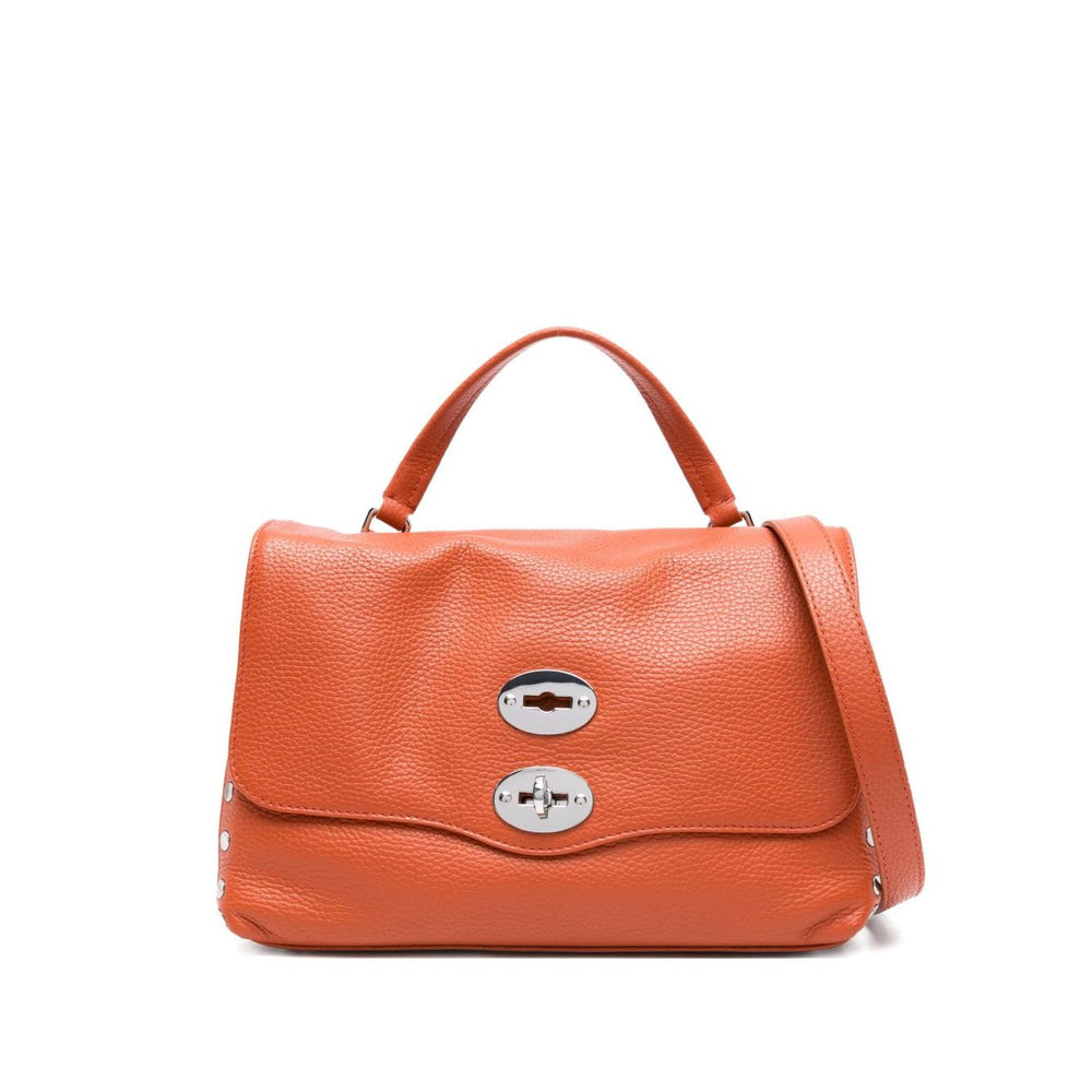 Zanellato Postina Daily Small leather handbag in orange with twist-lock, top handle, adjustable strap, and stud detailing.